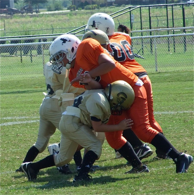 Image: Gage drives defender — Right offensive guard Gage Wafer chops down a Ferris lineman.