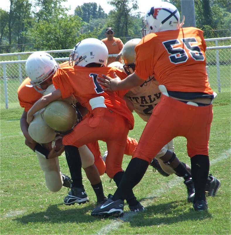 Image: Tylan covered in orange — Italy’s Majors (5th &amp; 6th) quarterback Tylan Wallace get surrounded by a wall of orange.