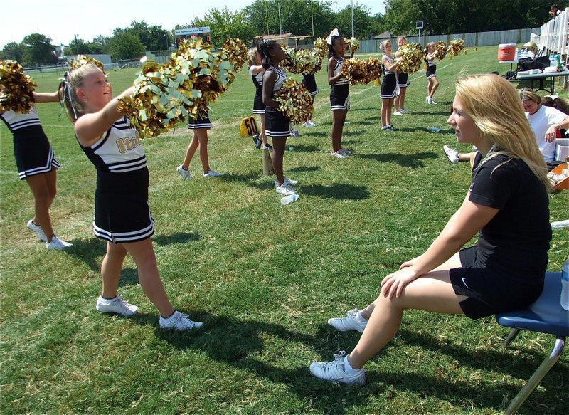 Image: Mary helps cheer — Varsity cheerleader Mary Tate volunteers her spare time to work with the IYAA Cheerleaders.