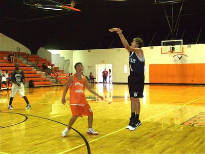 Image: Nice form — Colton Campbell spots up for a 3-point shot.
