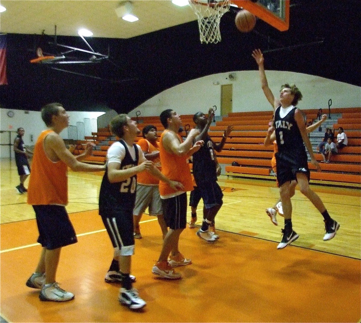 Image: Two more — Colton Campbell(1) works the baseline for a score as teammates Ryan Ashcraft(20) and Devonta Simmons get in rebounding position.