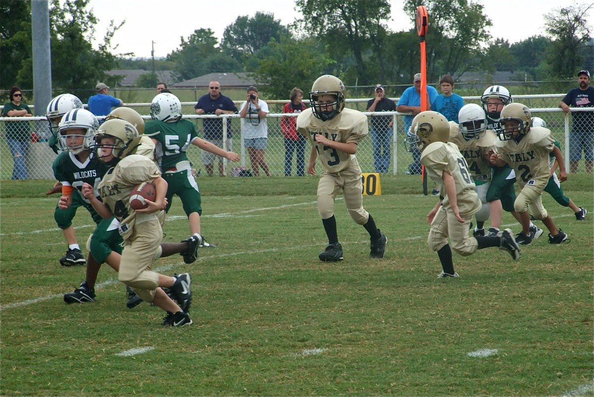 Image: Bryce DeBorde(44) breaks away against Scurry Rosser — Bryce DeBorde(44) runs downfield while Preston Rasco(13), Ty Cash(61), Byron Davis(14) and Jalyn Wallace(2) look for Wildcats to block during the IYAA Bantam game against Scurry-Rosser.