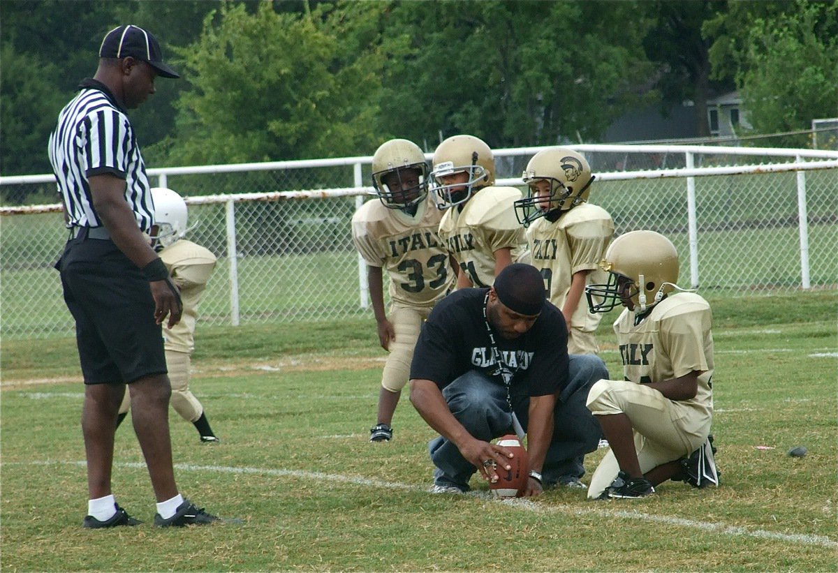 Image: Onside kick time — Special teams coach Corey Johnson sets up the ball for an onside kick attempt by Jaiden Barr while John Hall (white helmet), Julius Wilson(33), Laveranues Green (21) and Triston Hayes(9) get set to run down for the recovery.