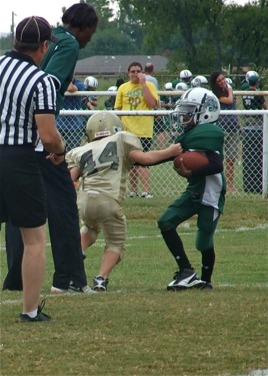 Image: Handful of Wildcat — Bryce DeBorde strong arms a Wildcat runner to the ground.