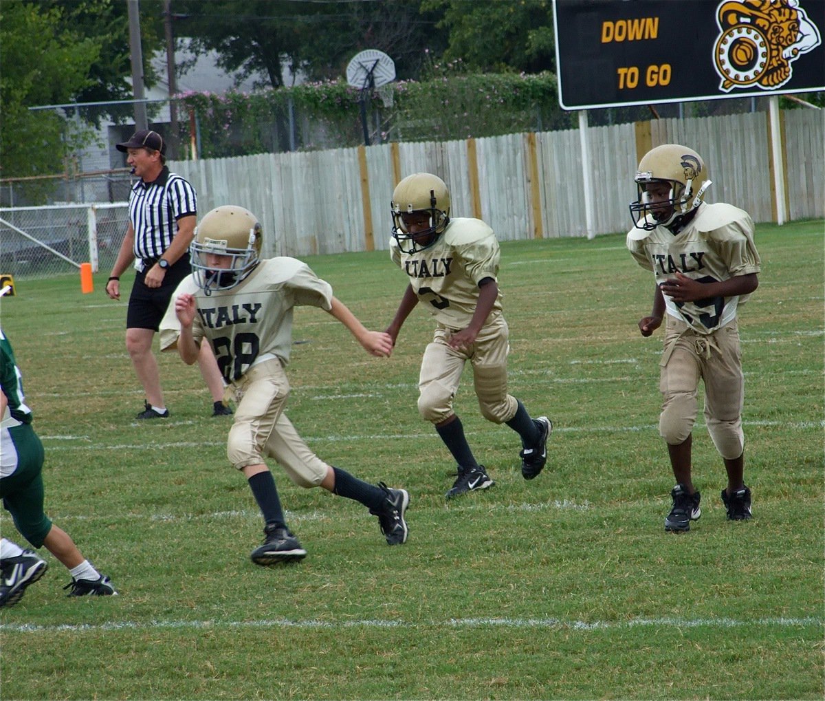 Image: Here we go! — Garret Cash, Ricky Pendleton and Christian Cole head downfield to block out of the trips left formation.