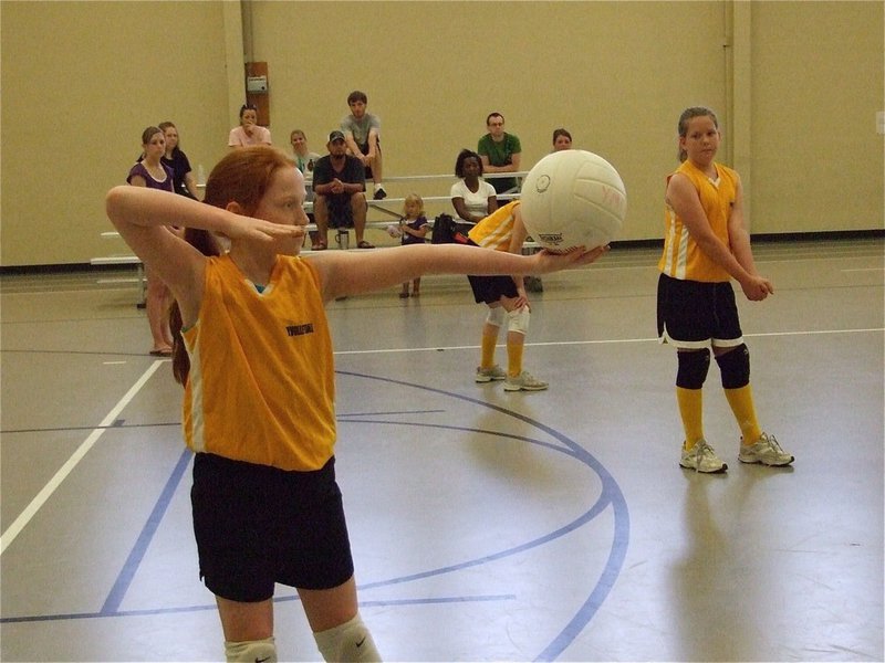 Image: Zoe zeros in — Zoe Brignon prepares to shoot an arrow over the net.