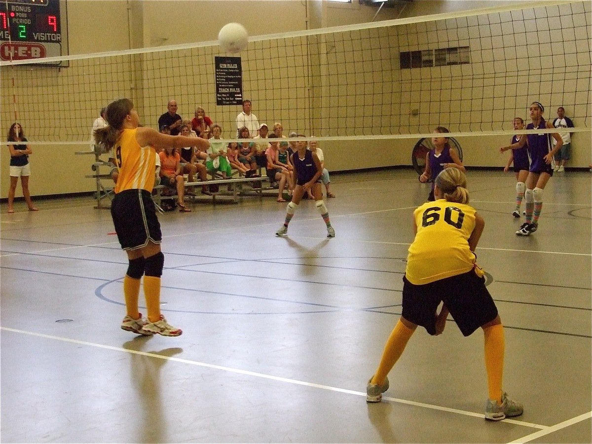 Image: Brooke gets it over — Brooke Salter(9) clears the net on the return from the middle blocker position while Cassidy Svehlak(60) plays her right side hitter position.