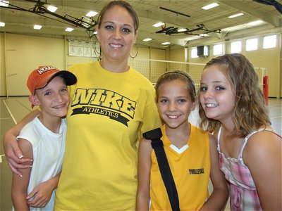 Image: Coach and her kids — Wild Thangs coach Tracey Bowles stands with her children Nathan, Haley and Peyton after the game.