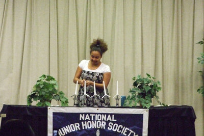 Image: Destani Anderson — Destani lights the candles for the induction ceremony.