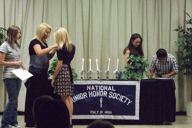 Image: The new pins — Megan Richards and Holli Love presented Sierra Harris with her pin. Cruz Enriquez and Cheyenne Frank sign the membership book.