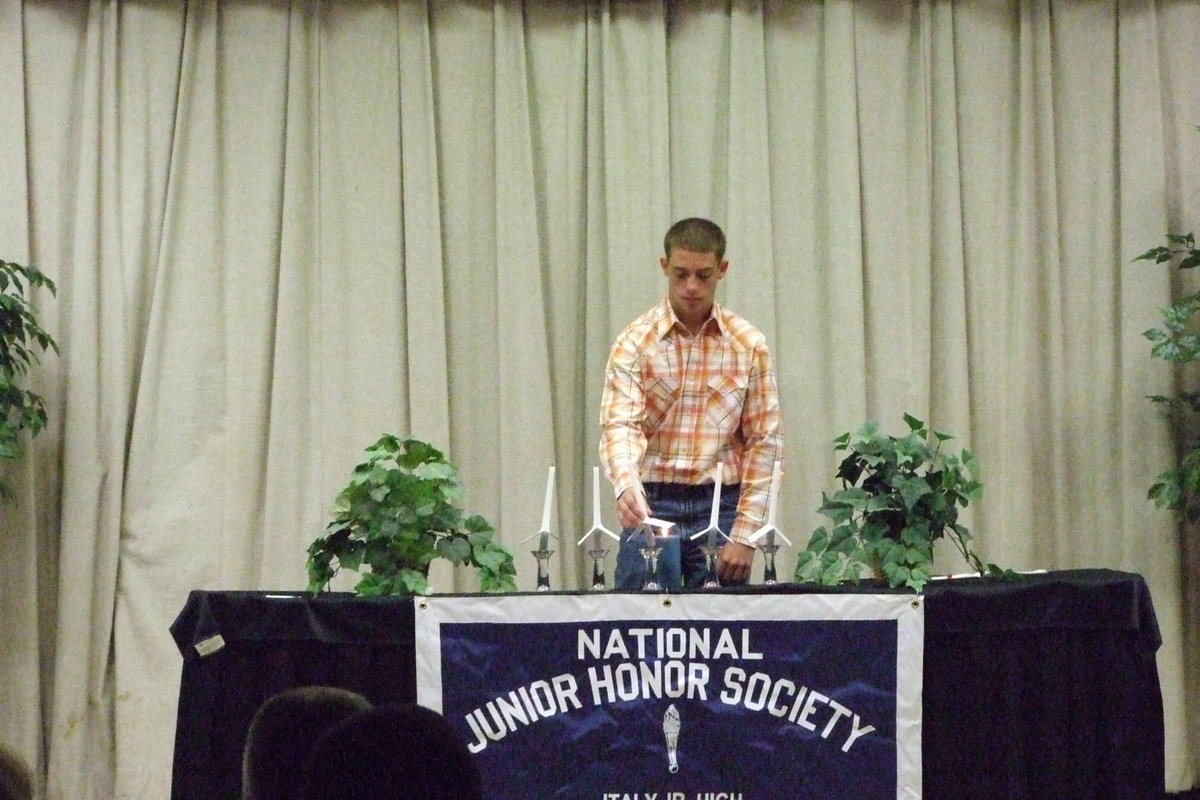 Image: Brandon Souder — Souder lights the officer’s candles.