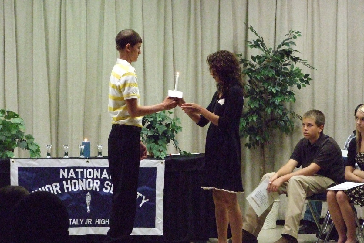 Image: Passing of the light — In this ceremony, Jase Holden passes his light to new officer, Anna Viers.