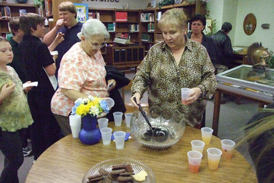 Image: Reception in the library — Mrs. Puckett serves Ann Byers some wonderful punch and cookies after the Induction Ceremony.
