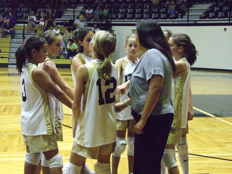 Image: 7th A team huddles with coach Tina Richards — “I love it when a plan comes together,” is the famous line from the A-Team!  The Lady Gladiators battled Grandview Lady Zebras on Monday night at the dome.