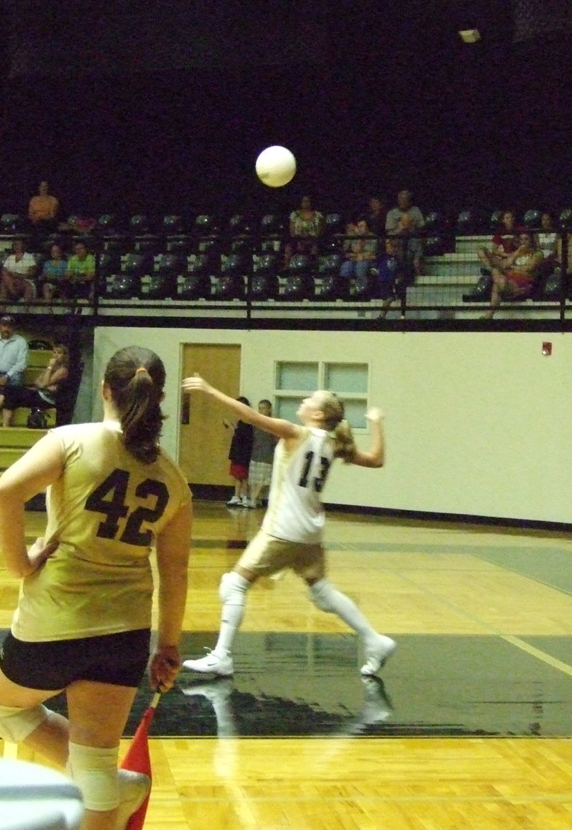 Image: Hannah is up and over — Hannah Washington (13) serves it right over the net.