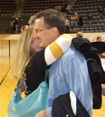 Image: Kristi &amp; Kyle — Head Coach Kyle Holley gets a warm embrace from wife Kristi after the big win over Clyde Eula.