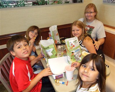 Image: All In The Family — Mikey South, who recently earned a game ball, enjoys McDonald’s Happy Meals™ with his sisters Catie and Evie South, cousin Sydney Lowenthal and Aunt Nan.