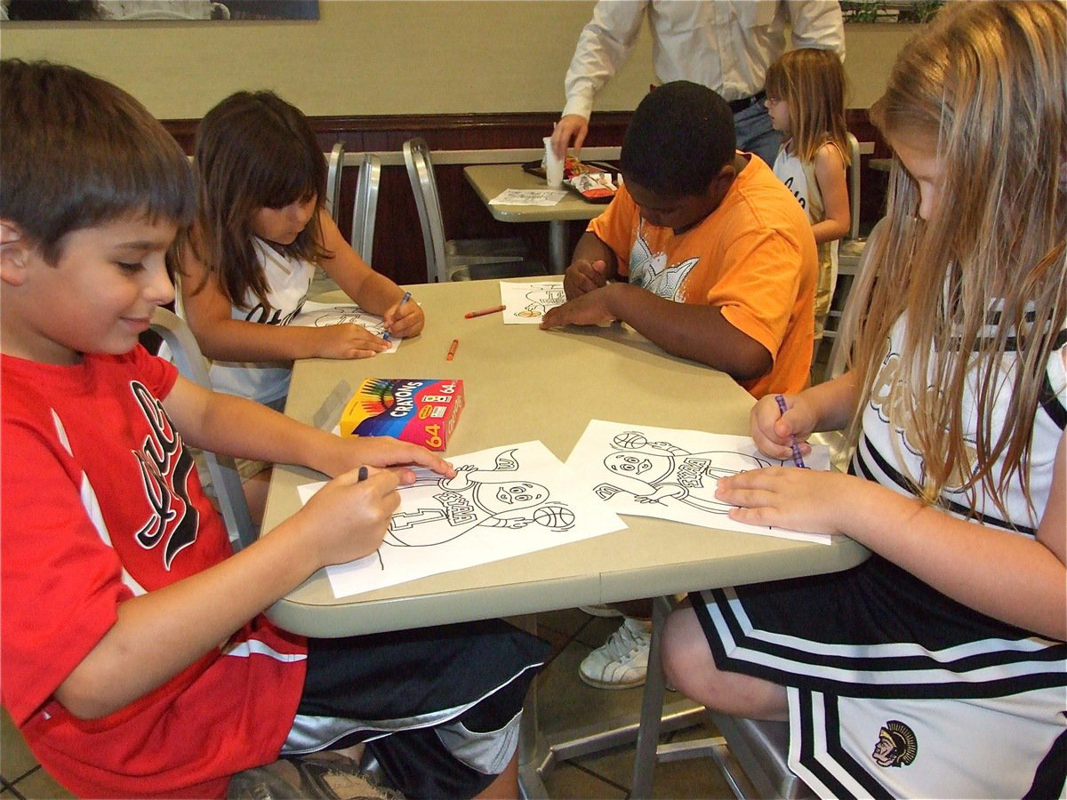 Image: Team work — Mikey South, Evie South, Ken Norwood and Sydney Lowenthal color Grimace as a group.