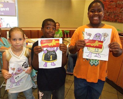 Image: So talented — Karley Nelson, Kendrick Norwood and Ken Norwood earn McDonald’s food coupons for their Grimace colorings.