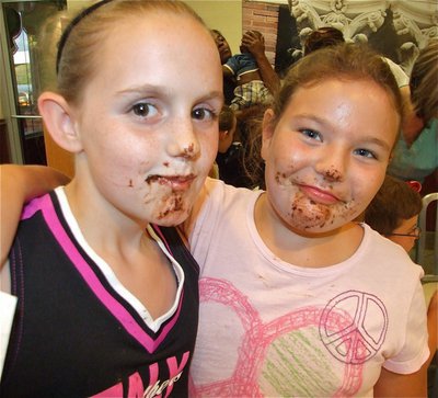 Image: Messy but fun — Kirby Nelson and Carlee Wafer display their chocolate covered faces after competing in the, no hands allowed, cookie eating contest.