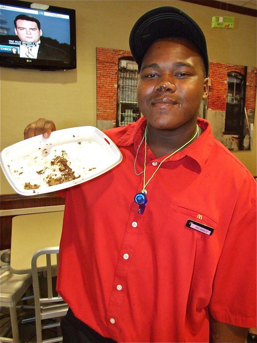 Image: Bobby gets messy — Bobby Wilson proudly displays his empty plate after impressively winning the cookie eating contest.