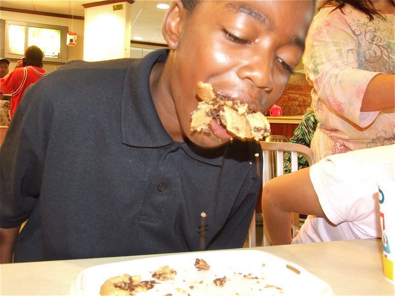 Image: The Cookie Kid — Kendrick Norwood has a mouthful of chocolate chip cookies during the cooking eating contest.