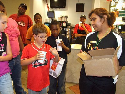 Image: The big moment — McDonald’s employee Maria Balderas holds the box while Gage Wafer draws the winner of the bike raffle. And the winner is, Kirby Nelson!