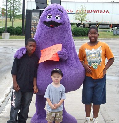 Image: Thanks, everybody! — Kendrick Norwood, Gared Wood and Kenneth Norwood help Grimace attract customers to the McDonald’s in Italy, helping to raise money for the IYAA (Italy Youth Athletic Association).