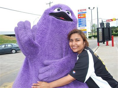 Image: Thanks, Grimace! — Maria Balderas gives Grimace a hug for being a good sport during IYAA Sports Night. Keanan Brown was all smiles inside the Grimace costume.