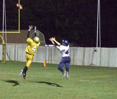 Image: Holden Blocks The Ball — Jase Holden leaps in the air to block the ball.