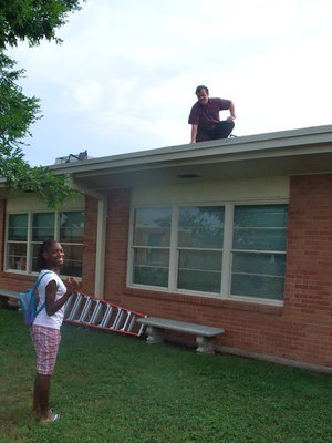 Image: McLean Forced to the Roof — Jonathan McLean is up on the roof again and Decorea Green (fifth grader) is proud of him for keeping his promise.