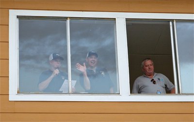Image: Pre-game show — Game announcer Richard Dabney, Paul “Mr. Personality” Cockerham and Greg Richards get settled inside the press box that overlooks Willis Field.