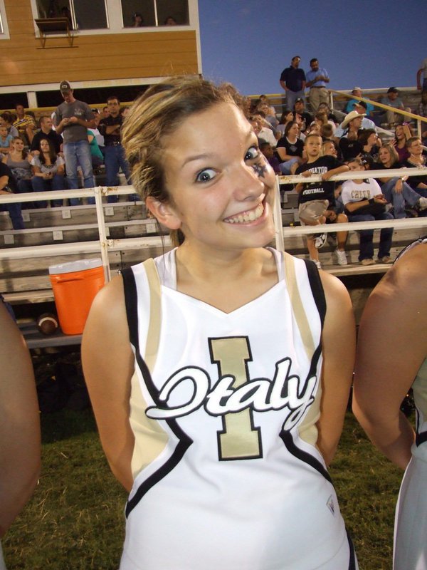 Image: She’s a hoot! — IHS Cheerleader Morgan Cockerham puts on her happy face during the game.