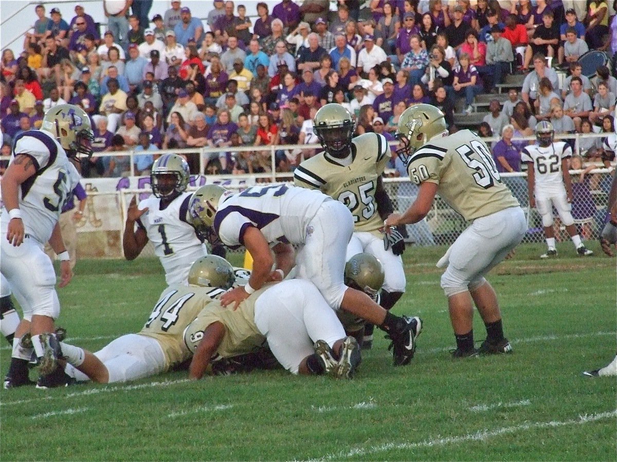 Image: We got him! — Gladiator defenders Ethan Saxon(44), Omar Estrada(56), Bobby Wilson(64), Corrin Frazier(25) and Ethan Simon(50) pile on a Panther runner.