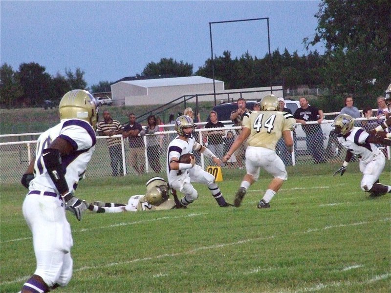 Image: Hanging on — Heath Clemons(2) tries to drag down a Panther from behind while Ethan Saxon(44) hurries in to assist.