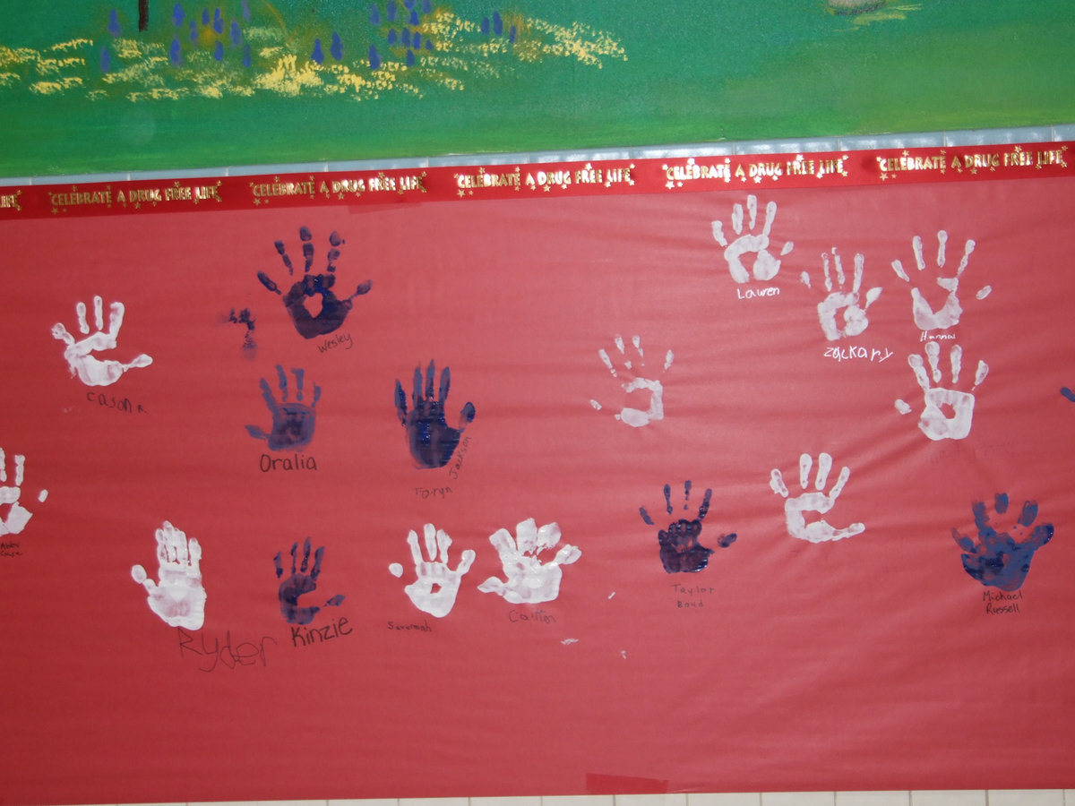 Image: Lots of hand prints — These handprints signify these students will not take drugs.