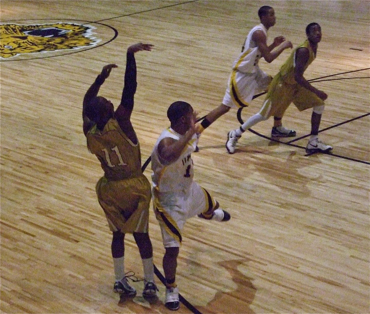 Image: Jas makes it! — Jasenio Anderson(11) knocks down a 3-pointer with a Wampus Cat in his face.