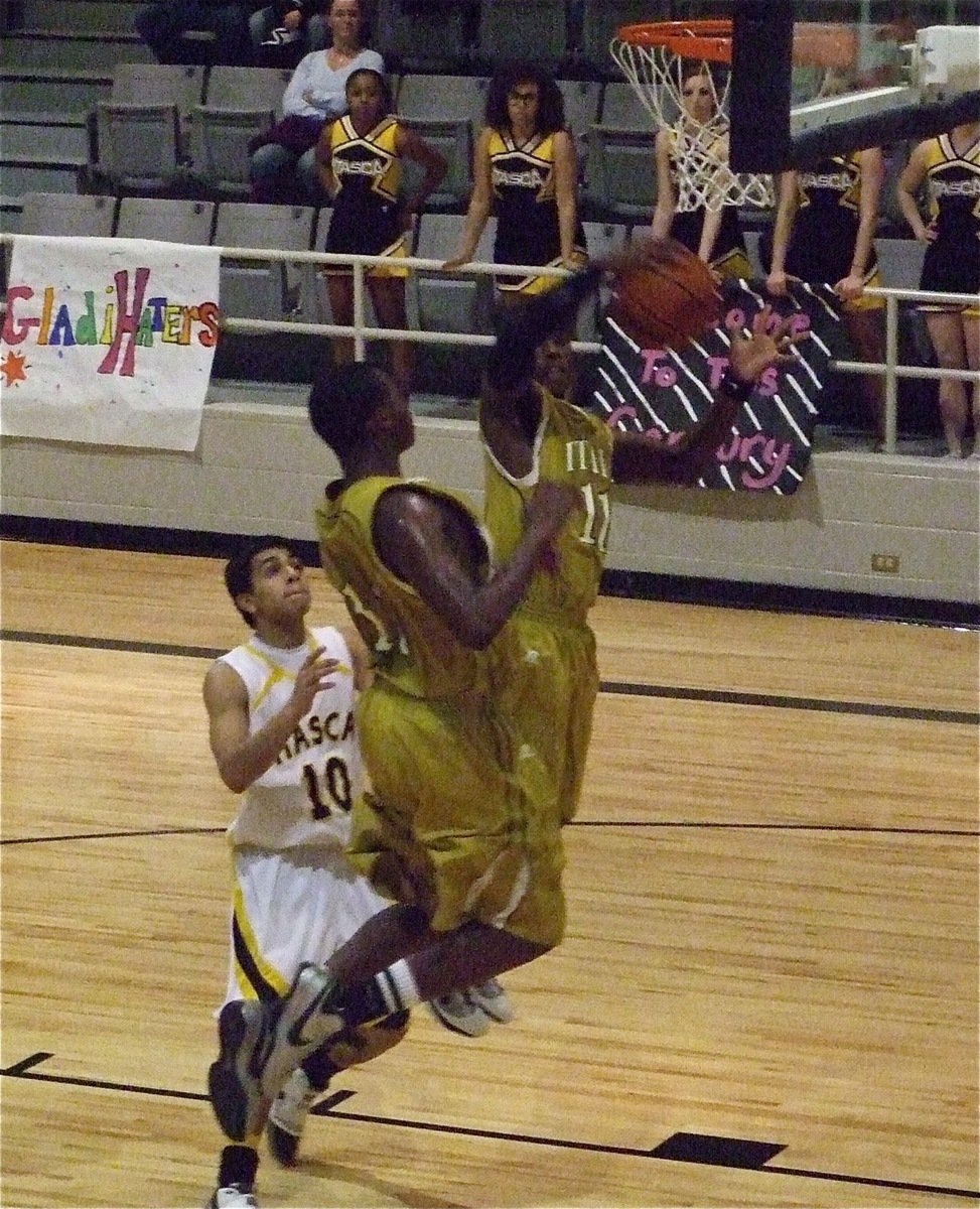 Image: Italy took it — Jasenio Anderson(11) and Larry Mayberry(13) leap into the air to secure a rebound.