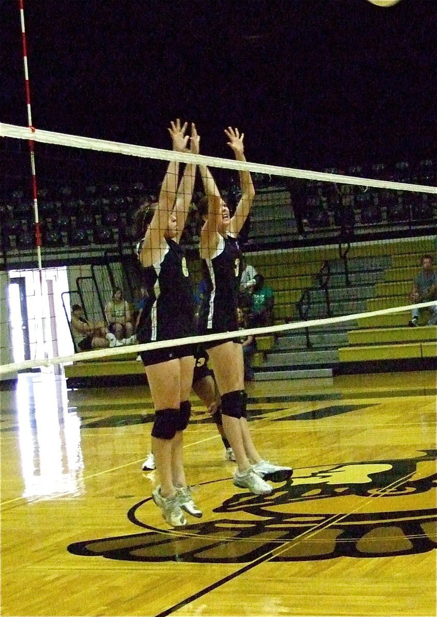 Image: Meeting the challenge — Bailey Bumpus(8) and Kaitlyn Rossa(3) try to challenge a rice return.