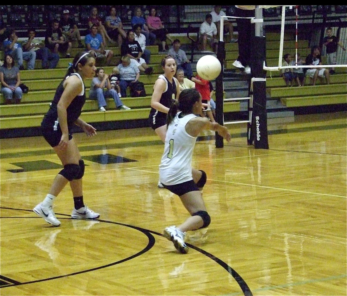 Image: Controlling the serve — Anna Viers(1) keeps the Rice serve alive as Alyssa Richards and Bailey Bumpus stand ready to react to the result.