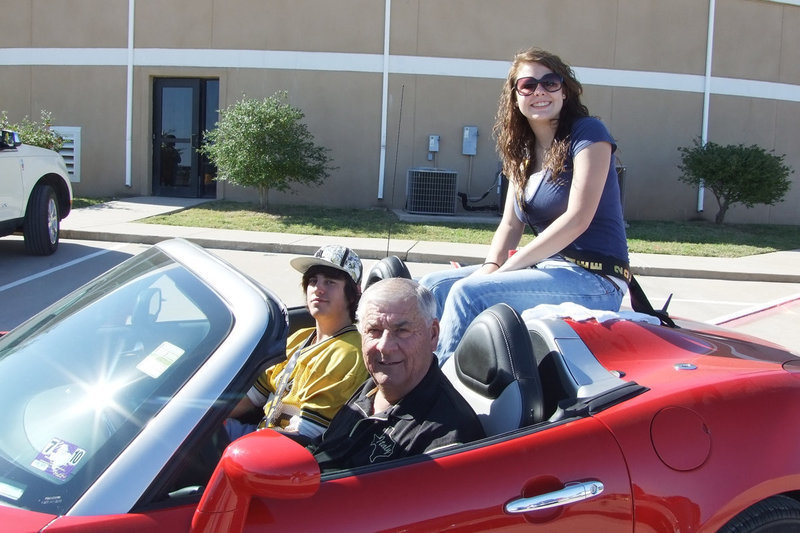 Image: Trevor and Stephanie — Homecoming nominee, Trevor Davis, and Queen nominee, Stephanie Carter, ride with Superintendent Jimmie Malone.