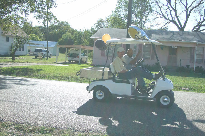 Image: Principal Herald and Coach — Coach Mayberry says hi to the crowds as they pass by.