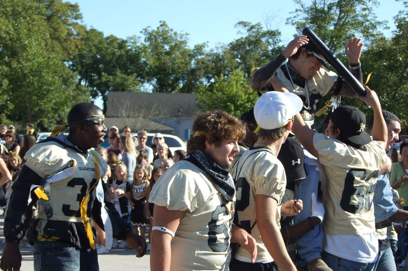 Image: “Crowning” the Homecoming King — Friends of Clay Major pelt him with inflatable bats, celebrating him being named Homecoming King.