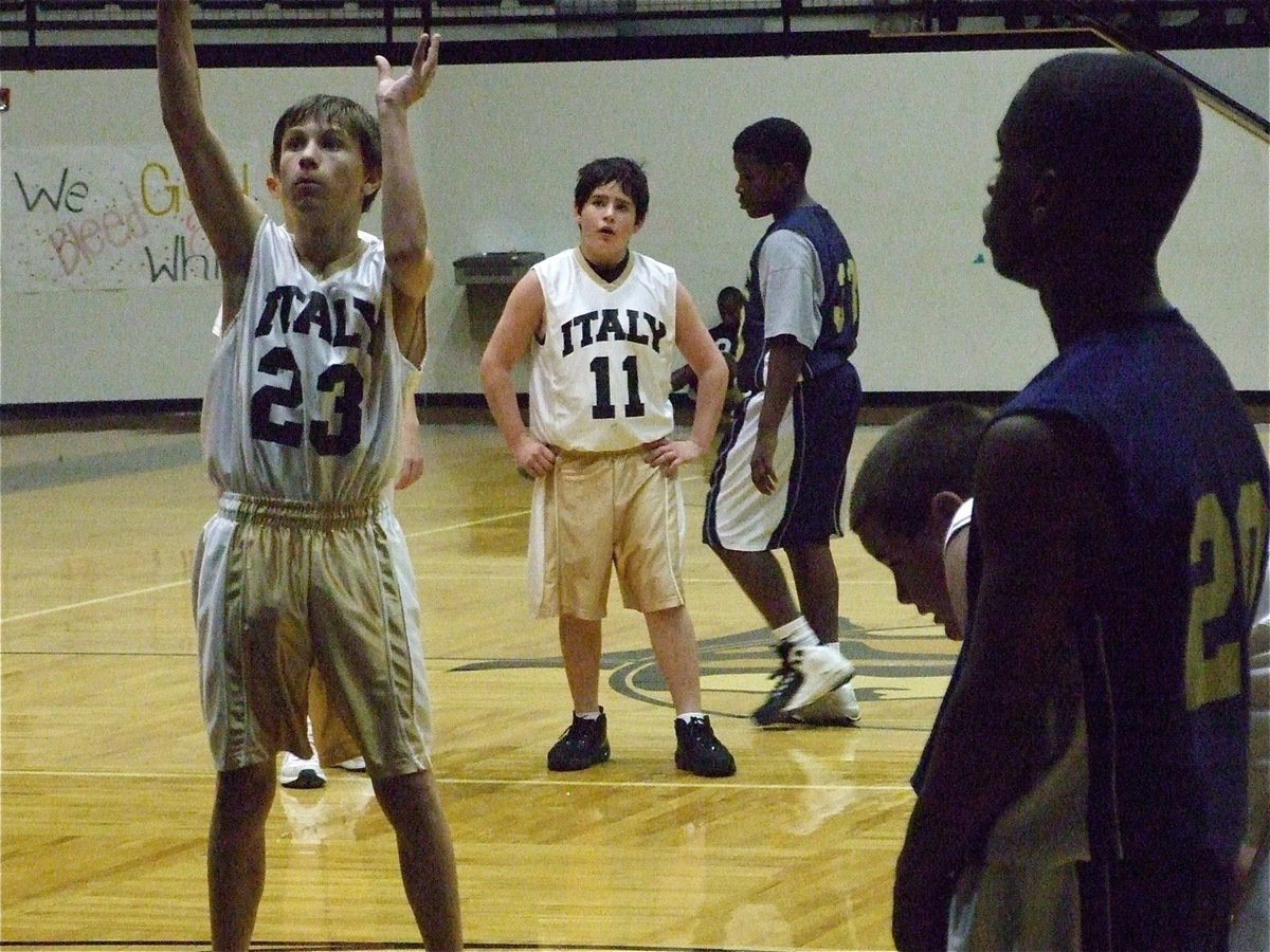 Image: Petrey takes a shot — Colton Petrey(23) shoots a freebie while Kyle Fortenberry(11) and Kelton Bales catch their breath.