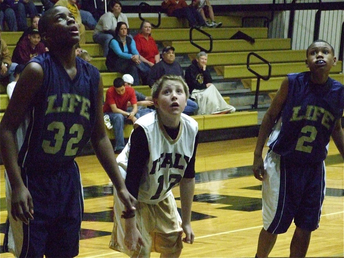 Image: John intimidates — John Escamilla(13) has no fear as he prepares to rebound a free throw against Dallas Life.