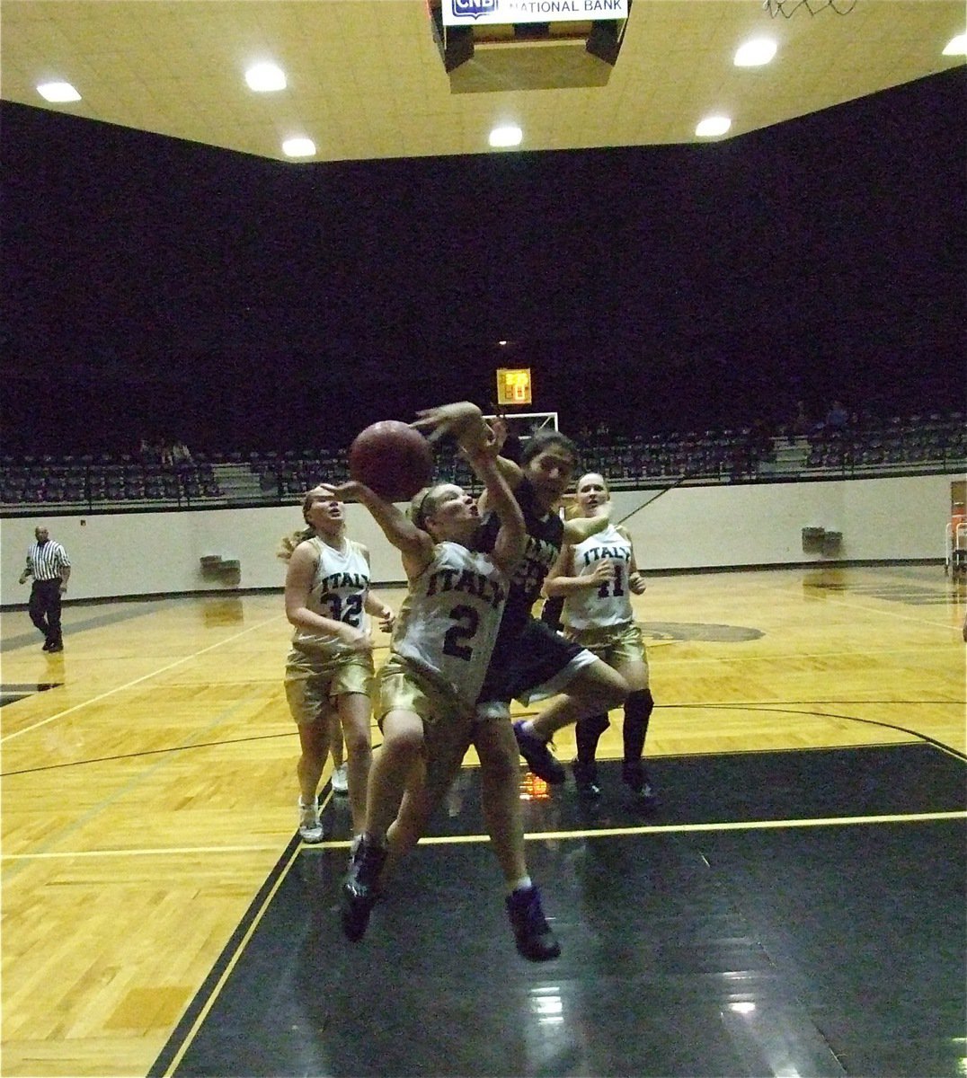 Image: No fear — Tara Wallis(2) shows no fear as she gets mauled on her way to the hoop.