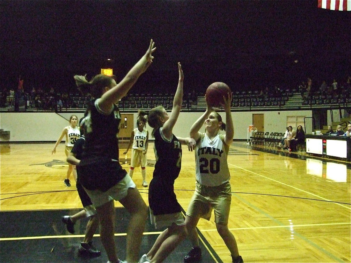 Image: Jesica shoots — 8th grader Jesica Wilkins(20) shoots over the Bulldog defense.