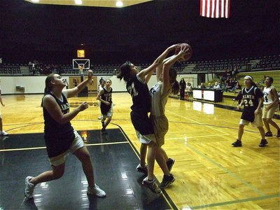 Image: Turner puts up a fight — Taylor Turner(31) gets hounded by a Lady Bulldog in a battle for the block.