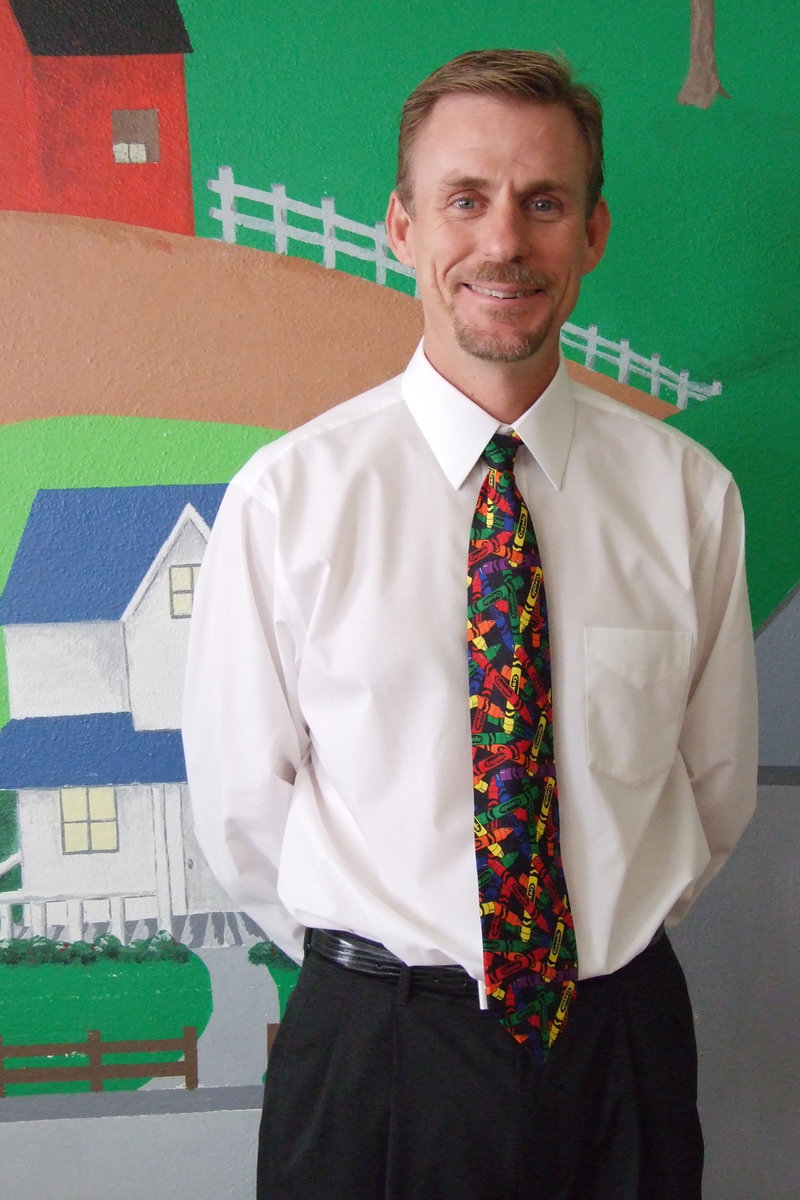 Image: IHS Principal, Scott Herald — Friendly smile and colorful tie, Mr. Herald welcomes everyone to Color Day during Homecoming Week.  Also, if you check, all of the colors of the classes are represented in his neckwear.