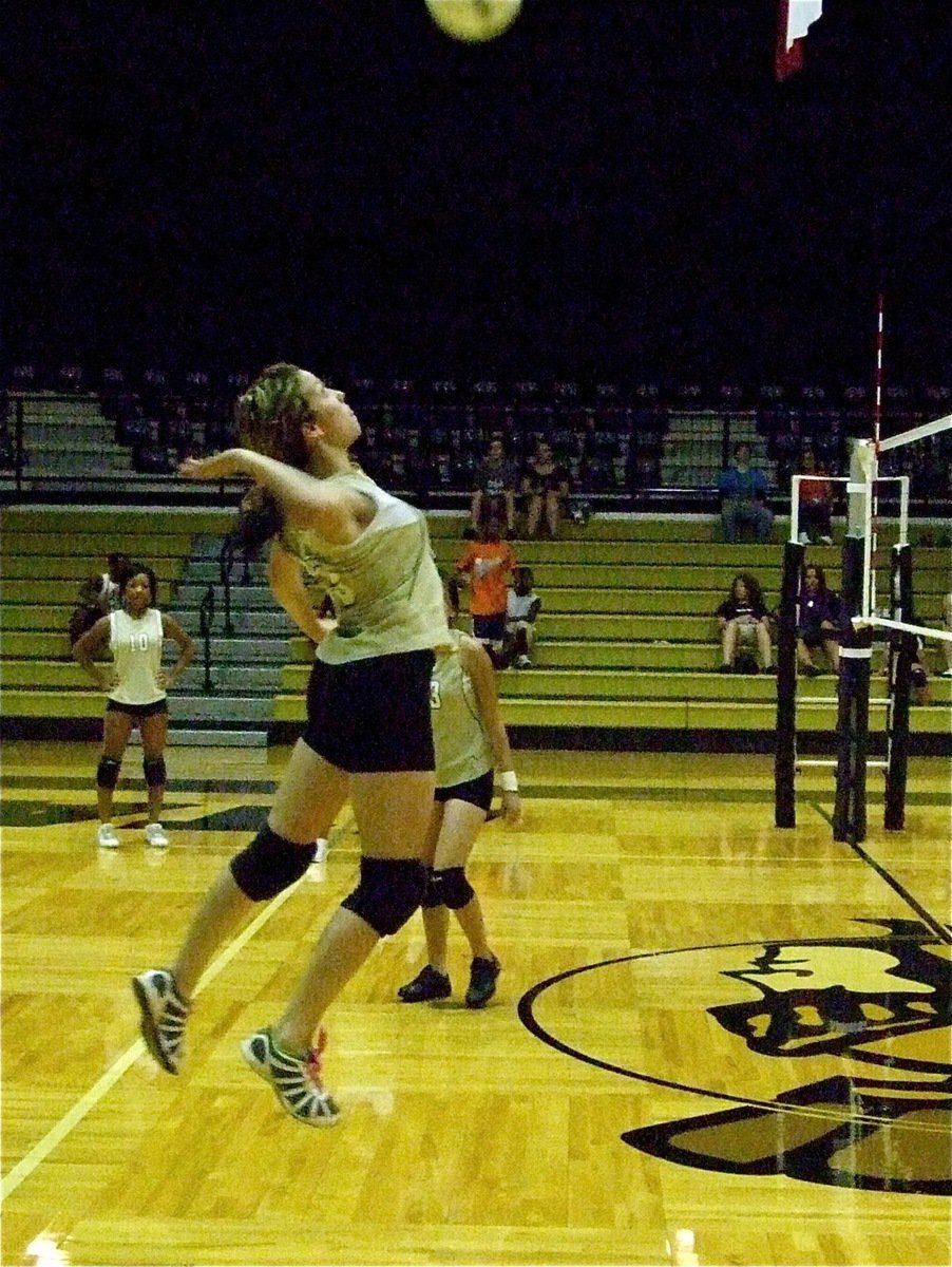 Image: The air up there — Morgan Cockerham takes a practice swing before the game J.V. game against Dawson.